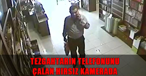 Tezgahtarın telefonunu çalan hırsız kamerada